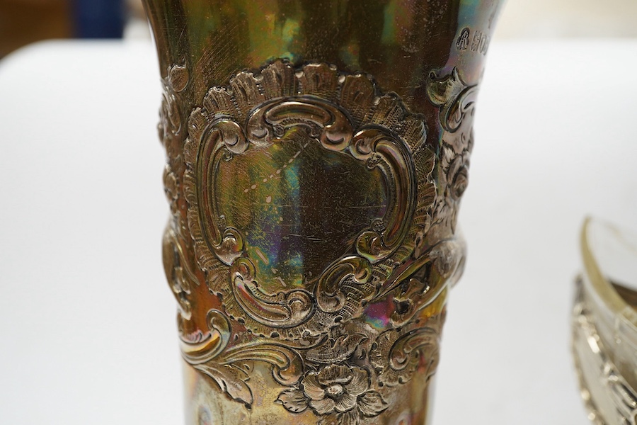 An Edwardian silver vase, embossed with hunting scene, with blue glass liner, Manoah Rhodes & Sons Ltd, London, 1901, 20.7cm, together with a German 800 white metal dish, on three supports. with damaged glass liner, 14.4